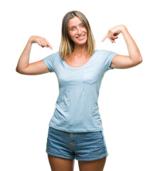 Fototapeta premium Young beautiful woman over isolated background looking confident with smile on face, pointing oneself with fingers proud and happy.