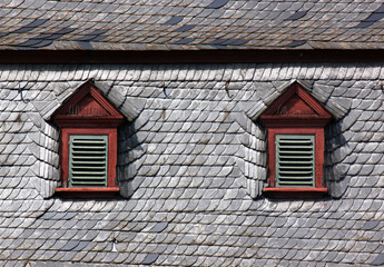 Black slate roof with baroque attic dormers on a city palace in the village of Zeltingen-Rachtig,...
