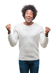 Fototapeta premium Afro american man over isolated background celebrating surprised and amazed for success with arms raised and open eyes. Winner concept.