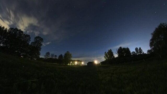 All night rural time lapse with starry sky, clouds, rain drops and hundreds of lightning bugs.
