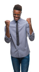 Young african american business man over isolated background very happy and excited doing winner gesture with arms raised, smiling and screaming for success. Celebration concept.