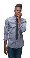 Fototapeta premium Young african american business man over isolated background looking stressed and nervous with hands on mouth biting nails. Anxiety problem.