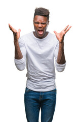 Fototapeta premium Young african american man over isolated background celebrating mad and crazy for success with arms raised and closed eyes screaming excited. Winner concept