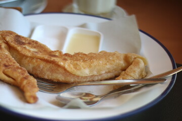Street hawker preparing prata bread or roti canai for morning breakfast