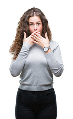 Beautiful brunette curly hair young girl wearing a sweater over isolated background shocked covering mouth with hands for mistake. Secret concept.