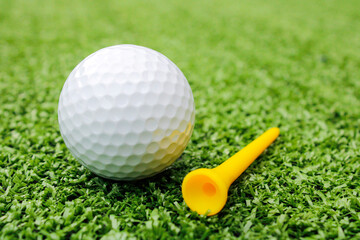 Golf ball placed on artificial grass.