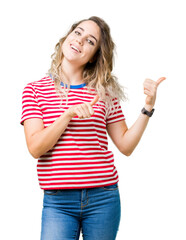 Beautiful young blonde woman over isolated background Pointing to the back behind with hand and thumbs up, smiling confident