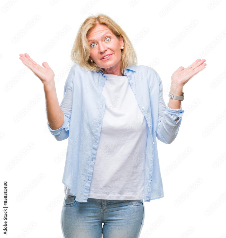 Poster Middle age blonde woman over isolated background clueless and confused expression with arms and hands raised. Doubt concept.