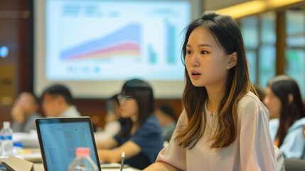 An Asian woman leading a digital marketing workshop, her laptop connected to a projector displaying a marketing presentation, with an attentive audience in the background 