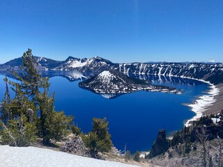 Crater Lake in the winter with snow covered mountains in the background