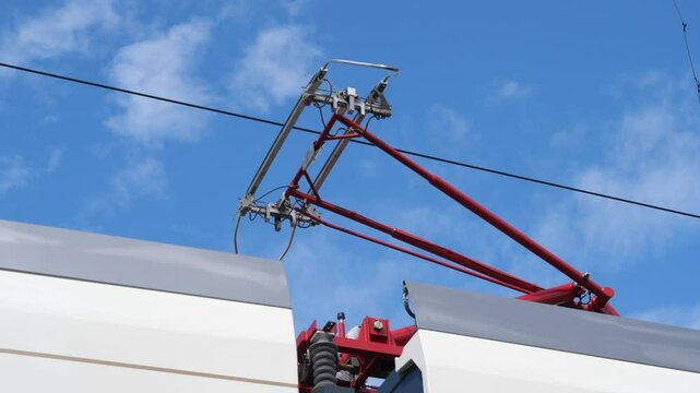electric train is connected to power. pantograph is connected to power line.