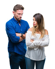 Young couple in love over isolated background skeptic and nervous, disapproving expression on face with crossed arms. Negative person.