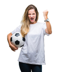 Young beautiful blonde woman holding soccer ball over isolated background annoyed and frustrated shouting with anger, crazy and yelling with raised hand, anger concept