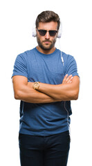 Fototapeta premium Young handsome man wearing headphones listening to music over isolated background skeptic and nervous, disapproving expression on face with crossed arms. Negative person.