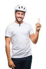 Young handsome man wearing cyclist safety helmet over isolated background with a big smile on face, pointing with hand and finger to the side looking at the camera.