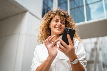 Portrait of adult woman stand in front business build use mobile phone