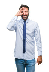 Fototapeta premium Adult hispanic business man over isolated background doing ok gesture with hand smiling, eye looking through fingers with happy face.