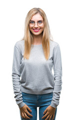 Young beautiful blonde woman wearing glasses over isolated background with a happy and cool smile on face. Lucky person.