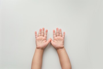 Two small baby hands reaching up against a white background, symbolizing growth and hope, perfect for themes of childhood and family