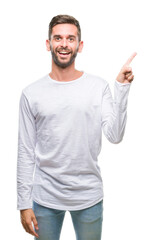 Young handsome man over isolated background with a big smile on face, pointing with hand and finger to the side looking at the camera.