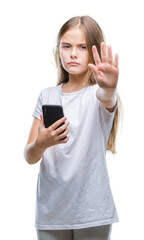 Fototapeta premium Young beautiful girl sending message texting using smarpthone over isolated background with open hand doing stop sign with serious and confident expression, defense gesture