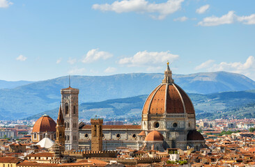 Fototapeta premium View of the Duomo Santa Maria del Fiore cathedral and Bell Tower of Giotto in Florence, Italy in a colorful sunset, aerial view