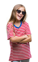 Young beautiful girl wearing sunglasses over isolated background happy face smiling with crossed arms looking at the camera. Positive person.