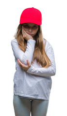 Young beautiful girl wearing red cap isolated background thinking looking tired and bored with depression problems with crossed arms.