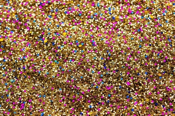Multicolored sparkle festive pink, yellow and blue confetti background.