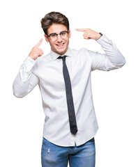 Young business man wearing glasses over isolated background Smiling pointing to head with both hands finger, great idea or thought, good memory