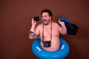 Dreams about the weekend. Funny fat man enjoys his vacation at the sea. Brown background.