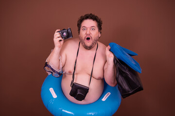 Dreams about the weekend. Funny fat man enjoys his vacation at the sea. Brown background.