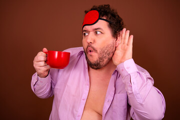 Early morning fresh gossip. Funny fat man drinking coffee. Brown background.