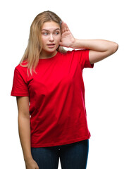 Young caucasian woman over isolated background smiling with hand over ear listening an hearing to rumor or gossip. Deafness concept.