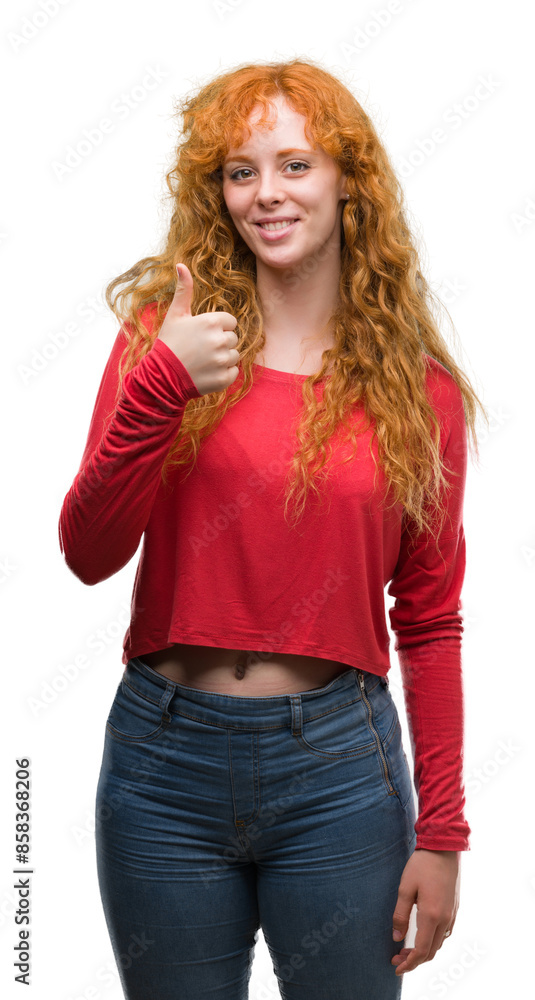 Poster young redhead woman happy with big smile doing ok sign, thumb up with fingers, excellent sign