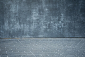 Interesting texture of a gray concrete wall with a floor with geometric figures in the form of triangles and diamonds