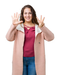 Beautiful plus size young woman wearing winter coat over isolated background showing and pointing up with fingers number eight while smiling confident and happy.