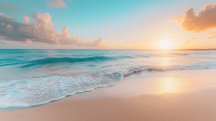 Obraz premium A stunning sunrise over a tropical beach, with the sun casting a warm glow over the gentle waves and sandy shore