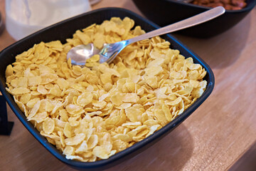 A bowl of cornflakes with a spoon. View from above. Selective focus