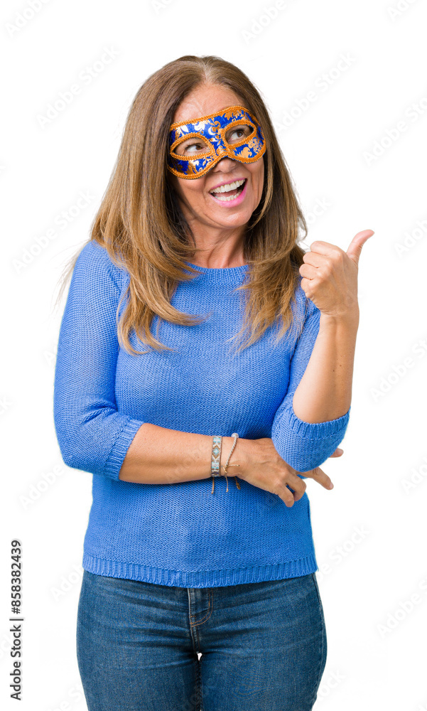 Poster Beautiful middle age woman wearing venice carnival mask over isolated background smiling with happy face looking and pointing to the side with thumb up.