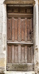 Old wooden door in a stoned ancient frame