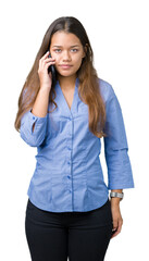 Fototapeta premium Young beautiful brunette business woman talking on smartphone over isolated background with a confident expression on smart face thinking serious