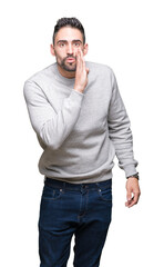 Fototapeta premium Young handsome man wearing sweatshirt over isolated background hand on mouth telling secret rumor, whispering malicious talk conversation