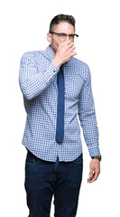 Young business man wearing glasses over isolated background smelling something stinky and...