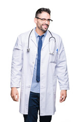 Handsome young doctor man over isolated background winking looking at the camera with sexy...