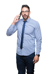 Young business man talking on the phone over isolated background scared in shock with a surprise face, afraid and excited with fear expression