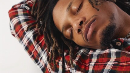 A person lying on their head, with dreadlocks visible