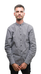 Fototapeta premium Young hipster man with serious expression on face. Simple and natural looking at the camera.