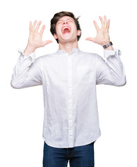 Fototapeta premium Young handsome business man over isolated background celebrating mad and crazy for success with arms raised and closed eyes screaming excited. Winner concept