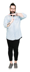 Young hipster man with long hair and beard wearing glasses Doing time out gesture with hands,...